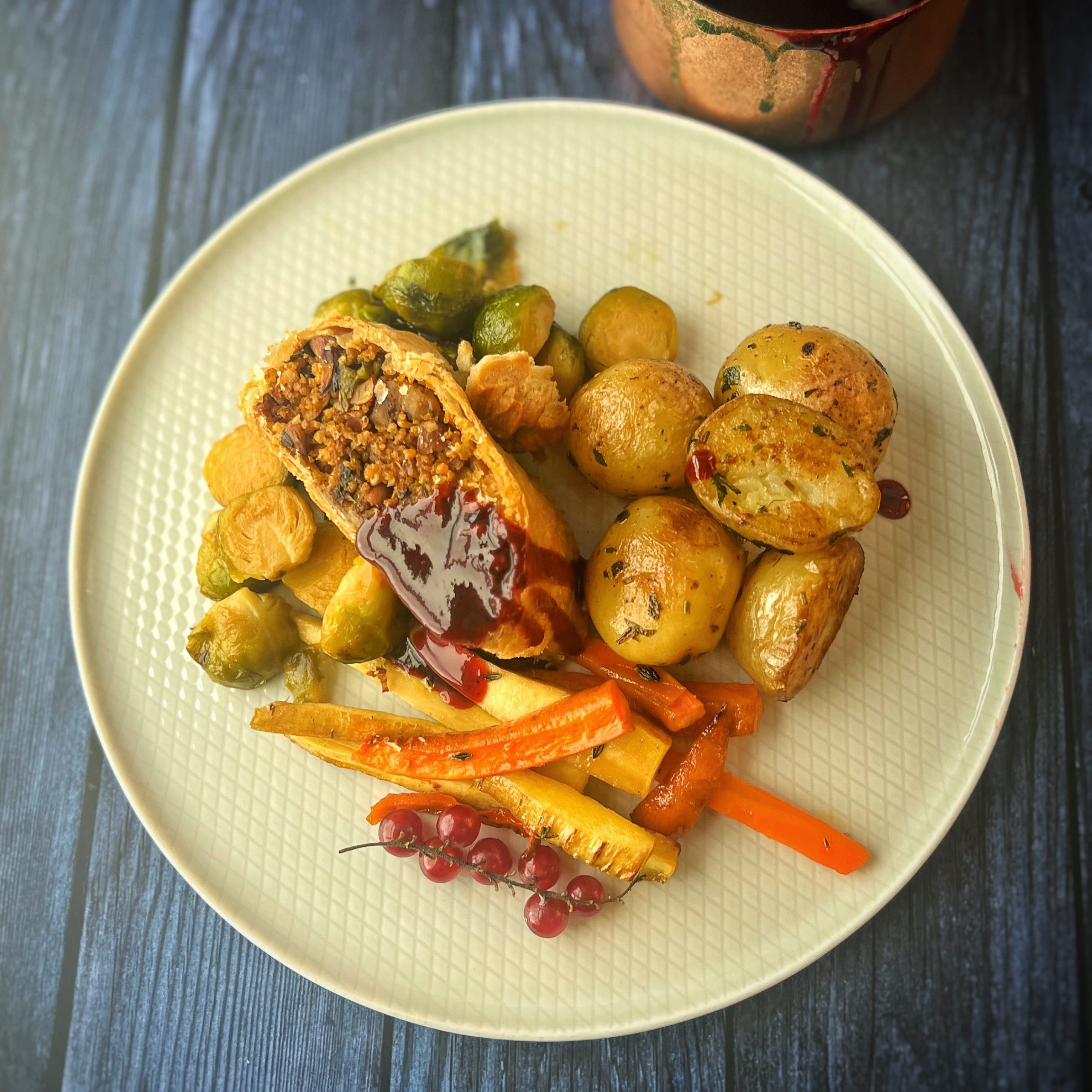 An image of Christmas mushroom and pumpkin Wellington with a red currant Jus