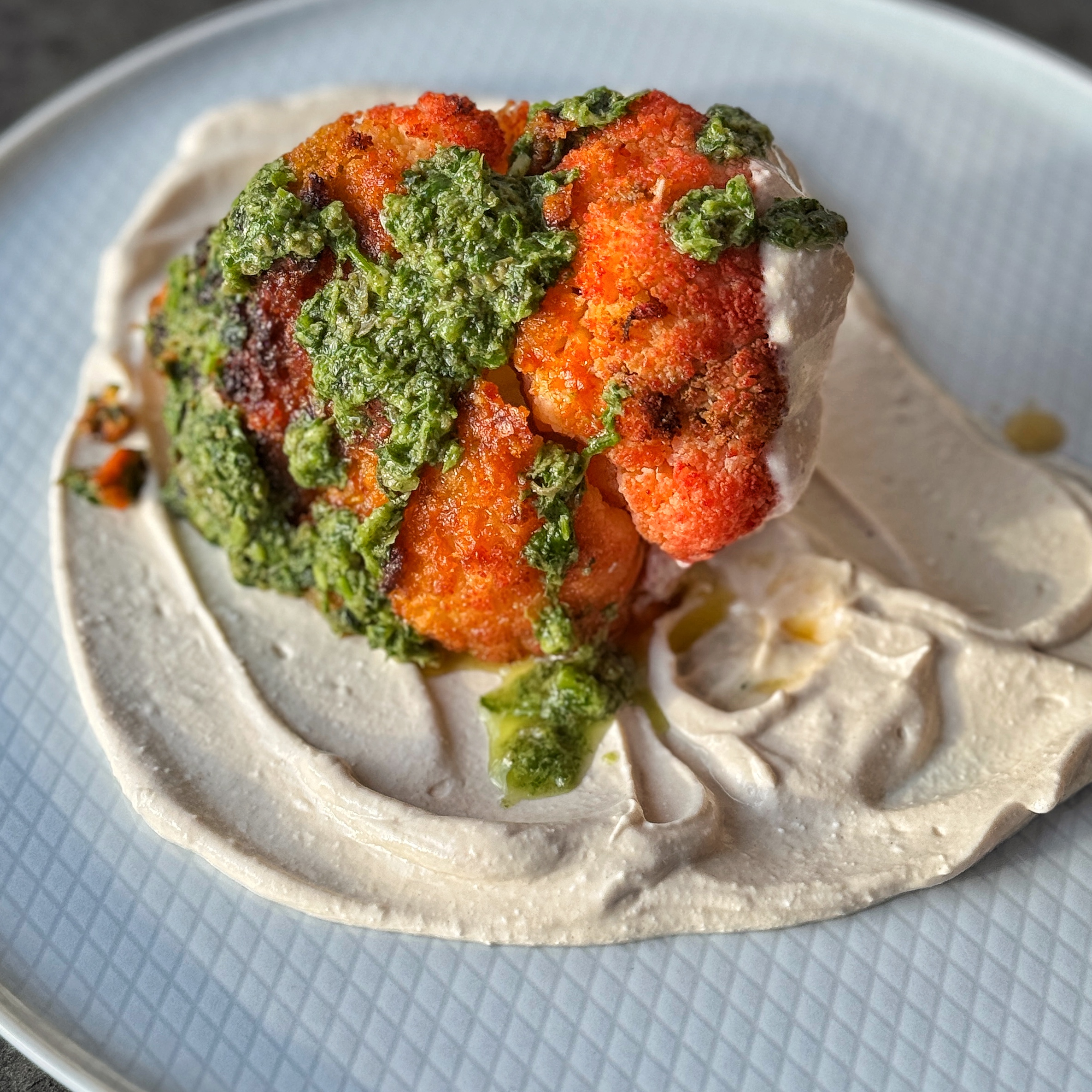 An image of Harissa Roasted Cauliflower with Tahini Cream and a Salsa Verde