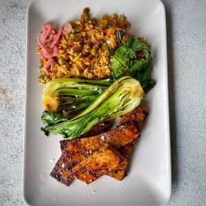 An image of Korean Barbecue Tofu with kimchi fried rice and greens