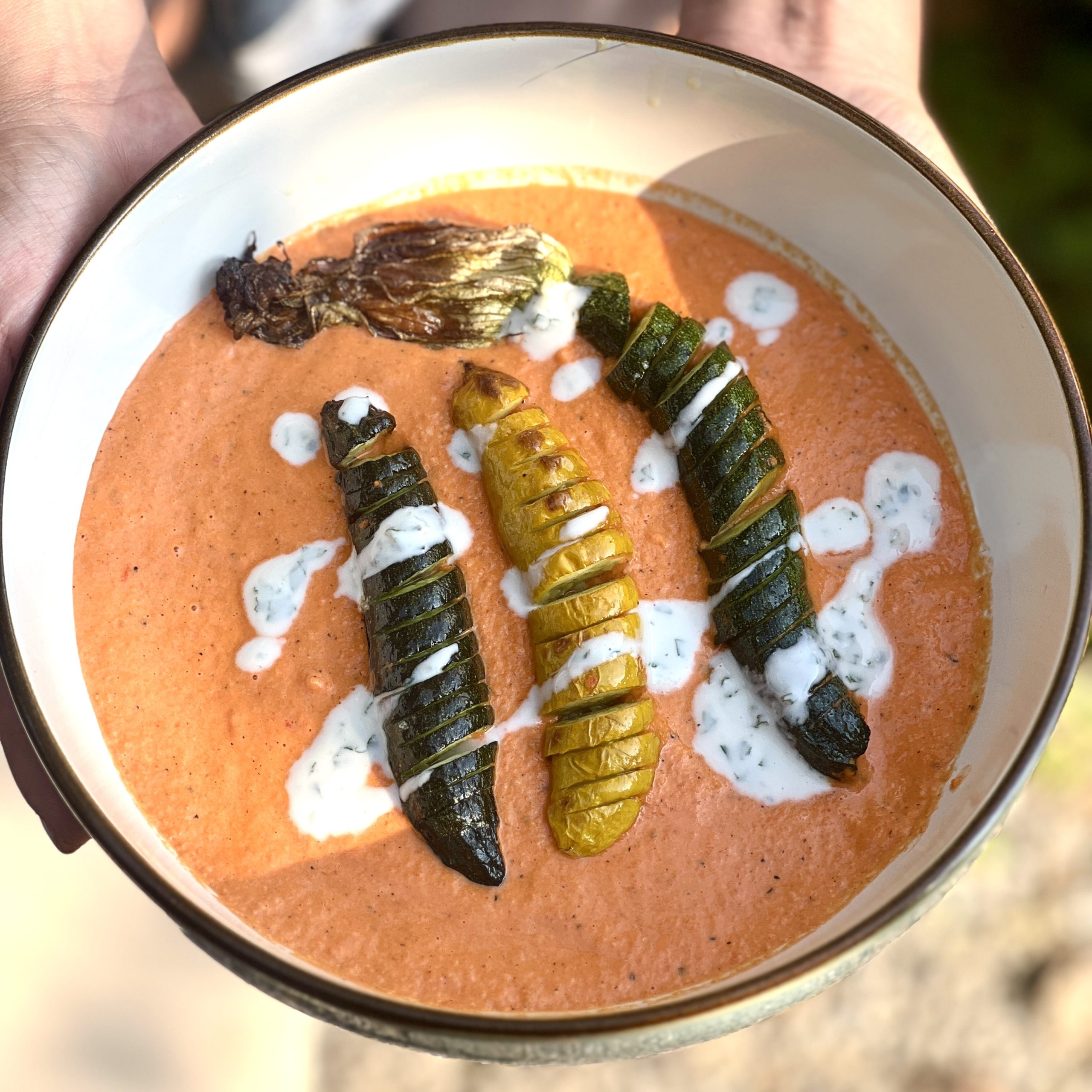 An image of Courgette hassleback with romesco sauce and mint yogurt