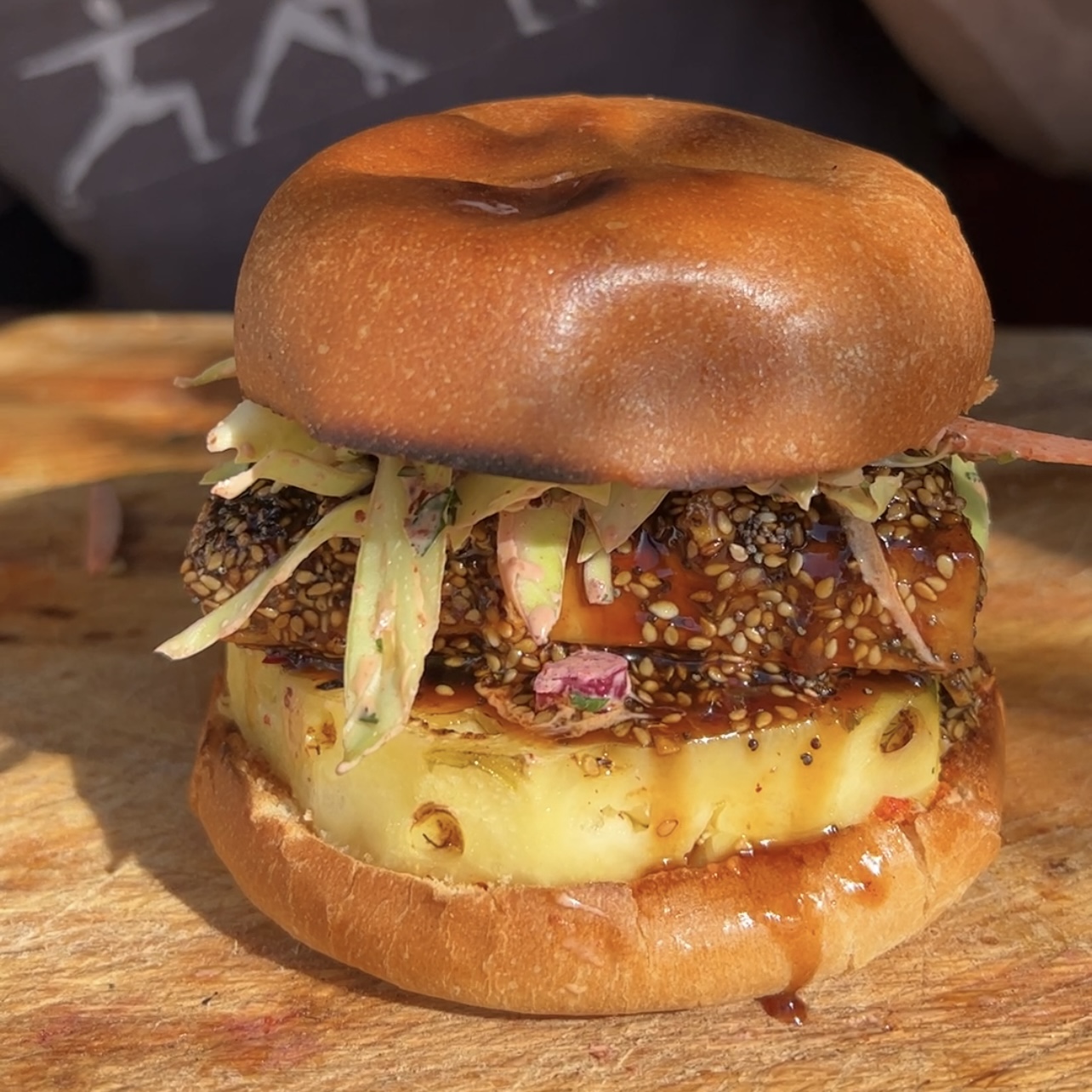 An image of Sticky Sesame Tofu Burger with charred Pineapple and Kimchi mayo