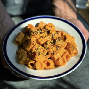 a photo of a bowl of high protein red pepper pasta