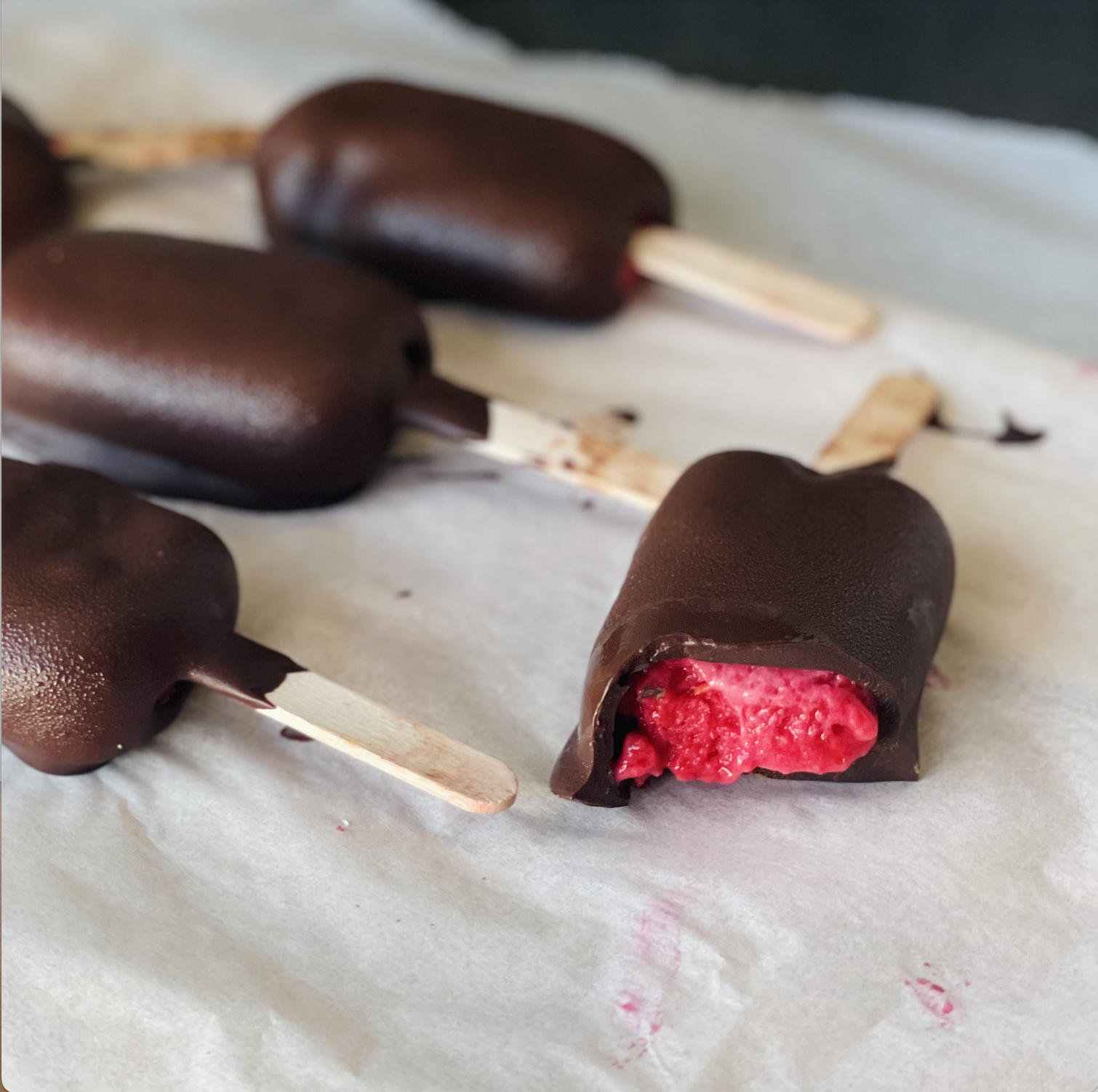 photo of homemade magnums with a raspberry filling and chocolate shell